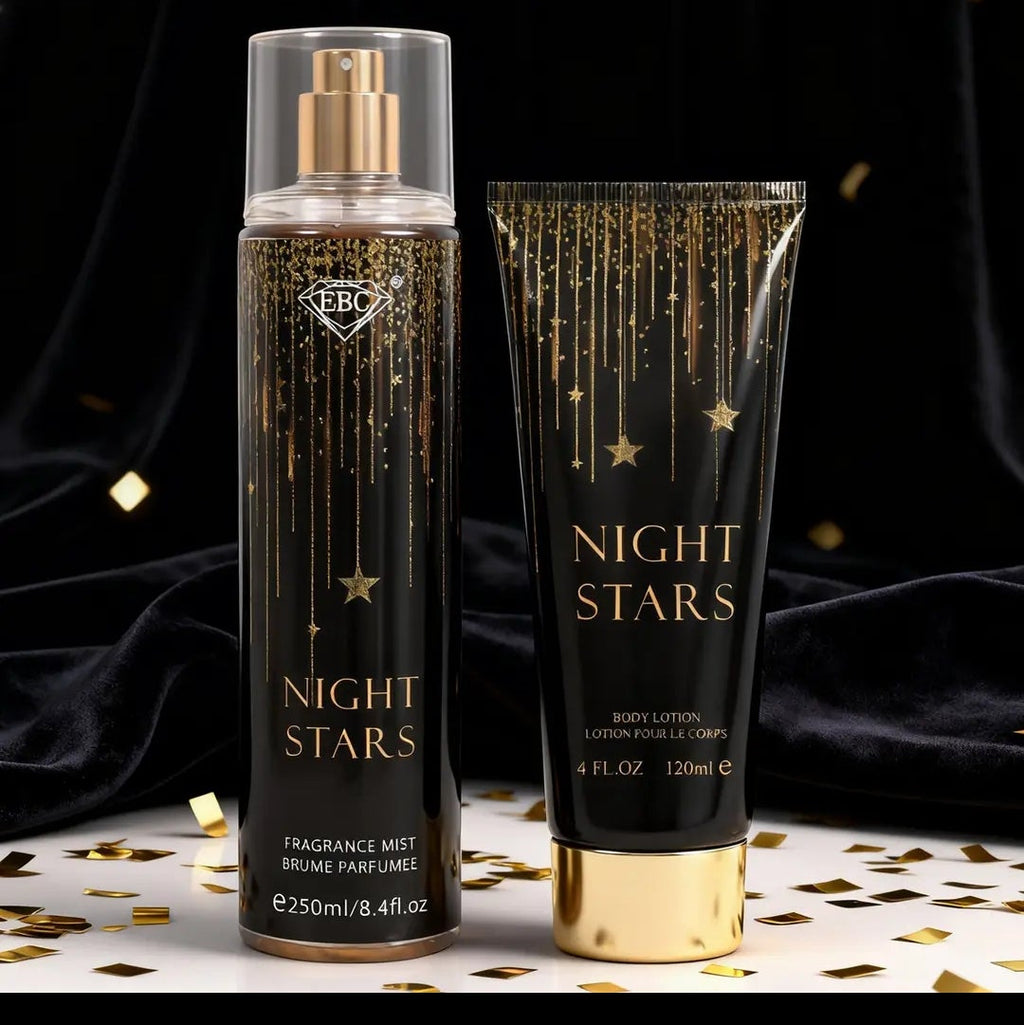 A perfume mist bottle and matching body lotion tube labeled NIGHT STARS, shown on a dark draped background with gold confetti. The packaging is black with gold lettering and star details, and both containers have gold caps.